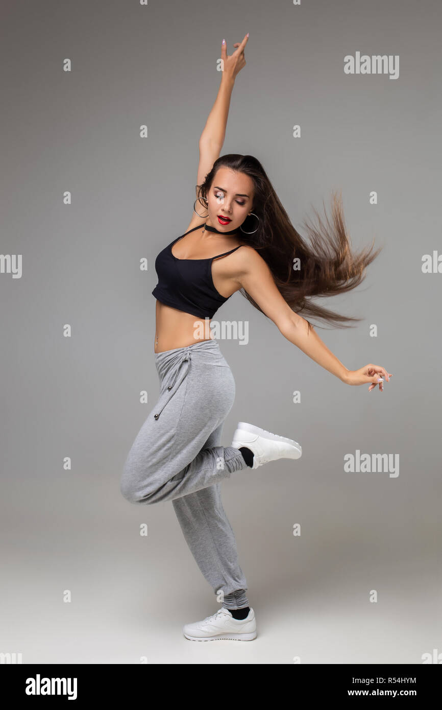 Modern Dancer Poses In Front Of The Gray Studio Background Modern Dance Styles Dancehall Jazz Funk Hip Hop Stock Photo Alamy