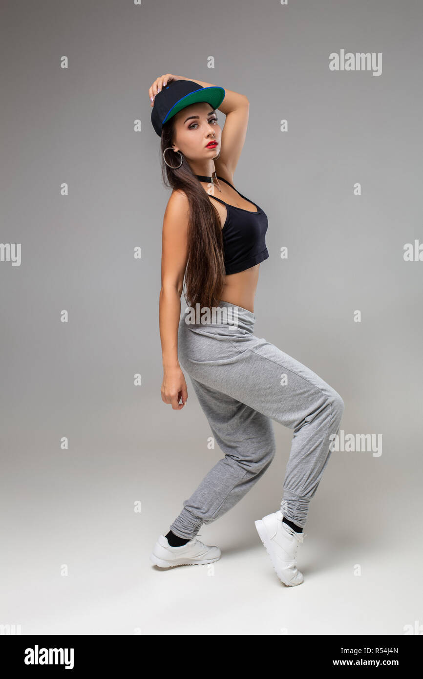 Modern dancer poses in front of the gray studio background. Modern ...