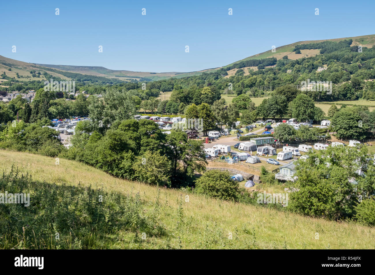 Caravan park in Summer with caravans among the hills and trees of the countryside near Hope, Derbyshire, Peak District National Park, England, UK Stock Photo