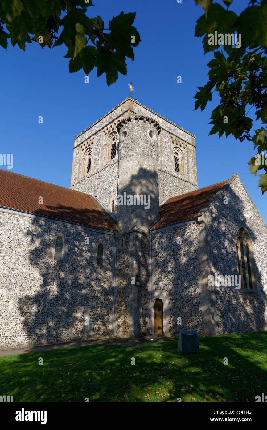 St Mary's church through tree branchs with leaves Kingsclere Hampshire Stock Photo