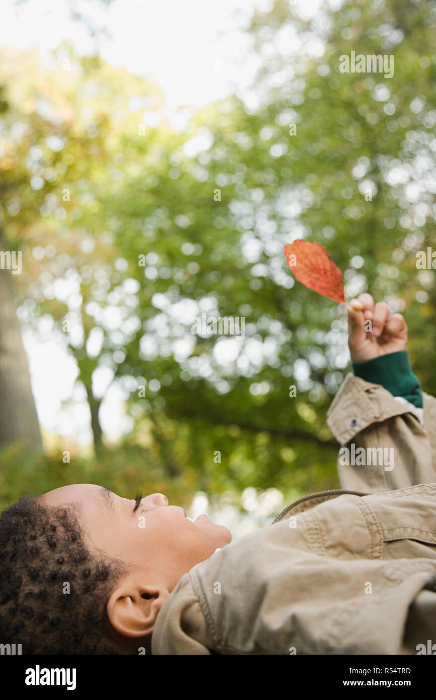 Boy holding a leaf Stock Photo - Alamy