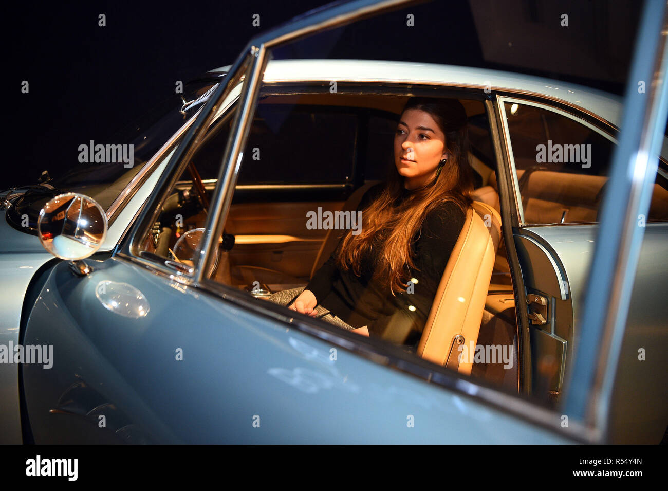 Auction house assistant Becky sits in a 1966 Ferrari 500 Superfast Series II Coupe, during a photo call for &pound;20m supercars before they are offered at auction, at Bonhams in New Bond Street, London. Stock Photo