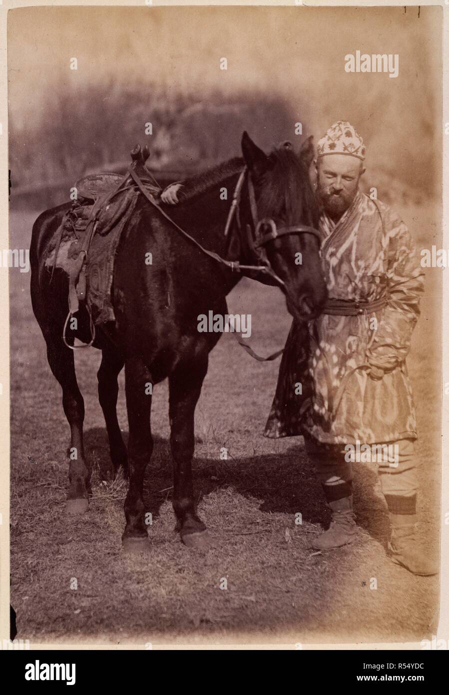 Chitrali and horse [?at Gilgit]. [Albumen print, 102x153mm]. 1885-6. Album of 'Photographs, Gilgit, Chitral, Yassin, Mastuch, &ca.' [Gilgit Mission]. The photographs are recorded as having been sent from India to the Secretary of State in August 1886., August 1886,. Source: Photo 1040/77. Author: Giles, George Michael James. Stock Photo