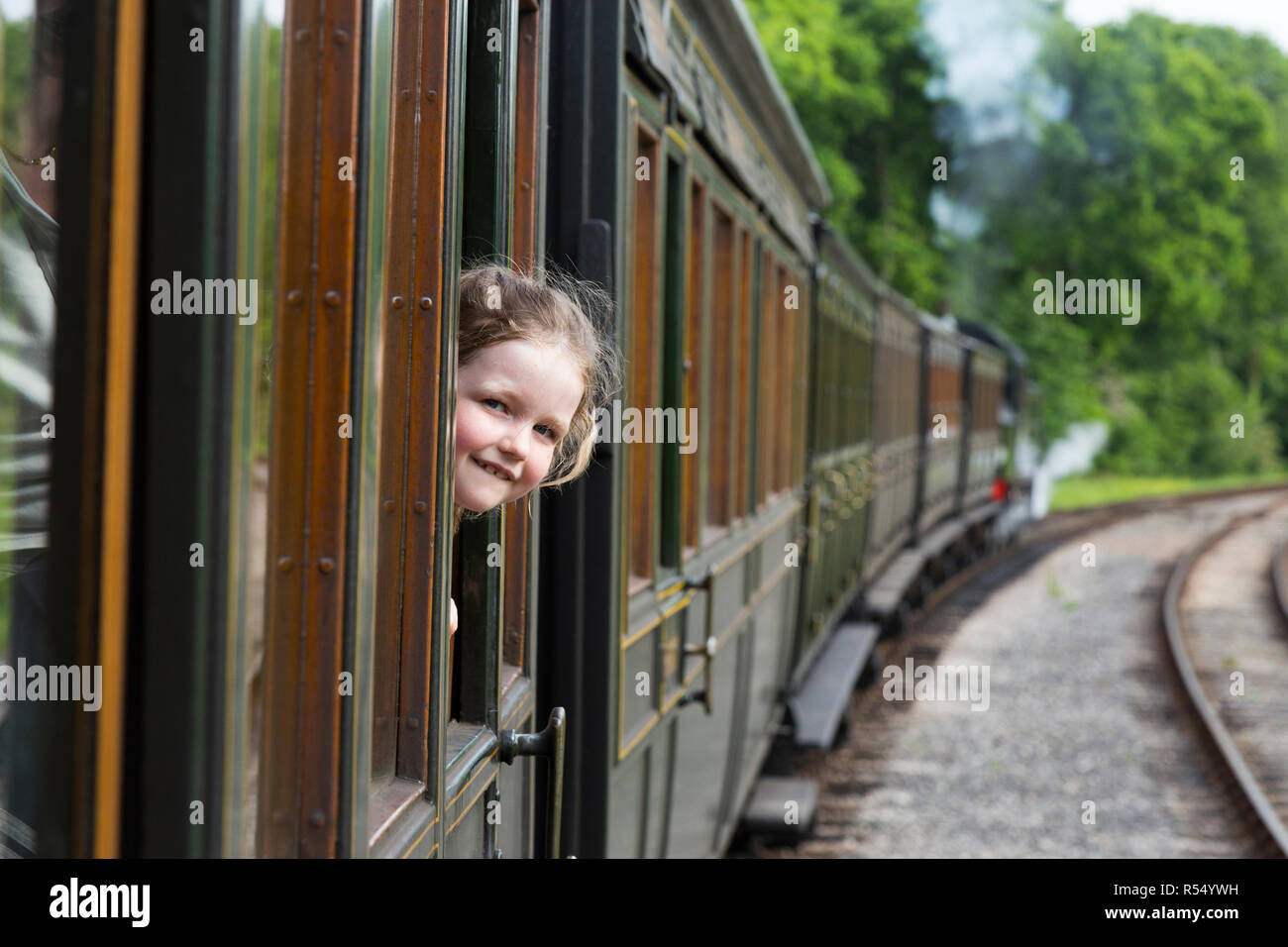 Passenger young girl aged 6 / six years old, smiling & looking out of