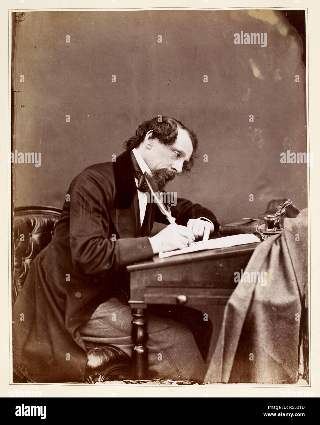 Charles Dickens sitting at his writing desk. The life of Charles Dickens. London: Chapman & Hall, 1872-74. Source: Dex.316 f.129. Author: FORSTER, JOHN. Stock Photo