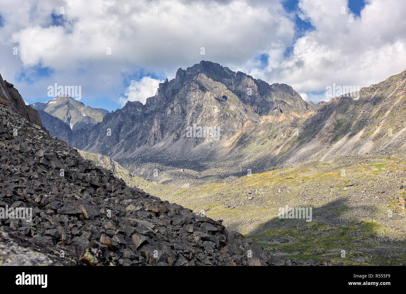 Collapsing peak under the influence of natural weathering erosion. Mountain landscape. Summer day. Central Asian Stock Photo
