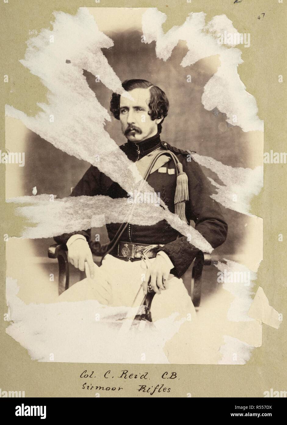 Col. C. Reid C.B. Sirmoor Rifles. A three-quarter length seated portrait, in uniform, of Col. (later General Sir) Charles Reid (1819-1901), Bengal Native Infantry. The print has been severely damaged by attempts to separate it from the page. Album of portraits of Indian Army officers and Indian views. c. 1860. Albumen print. Source: Photo 31/1(47). Language: English. Author: UNKNOWN. Stock Photo