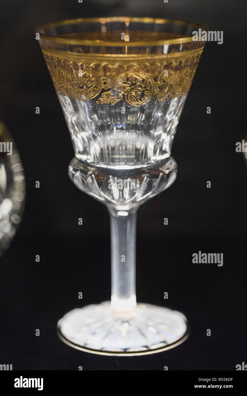 Close up of white hand cut lead crystal glass with golden edge, germany