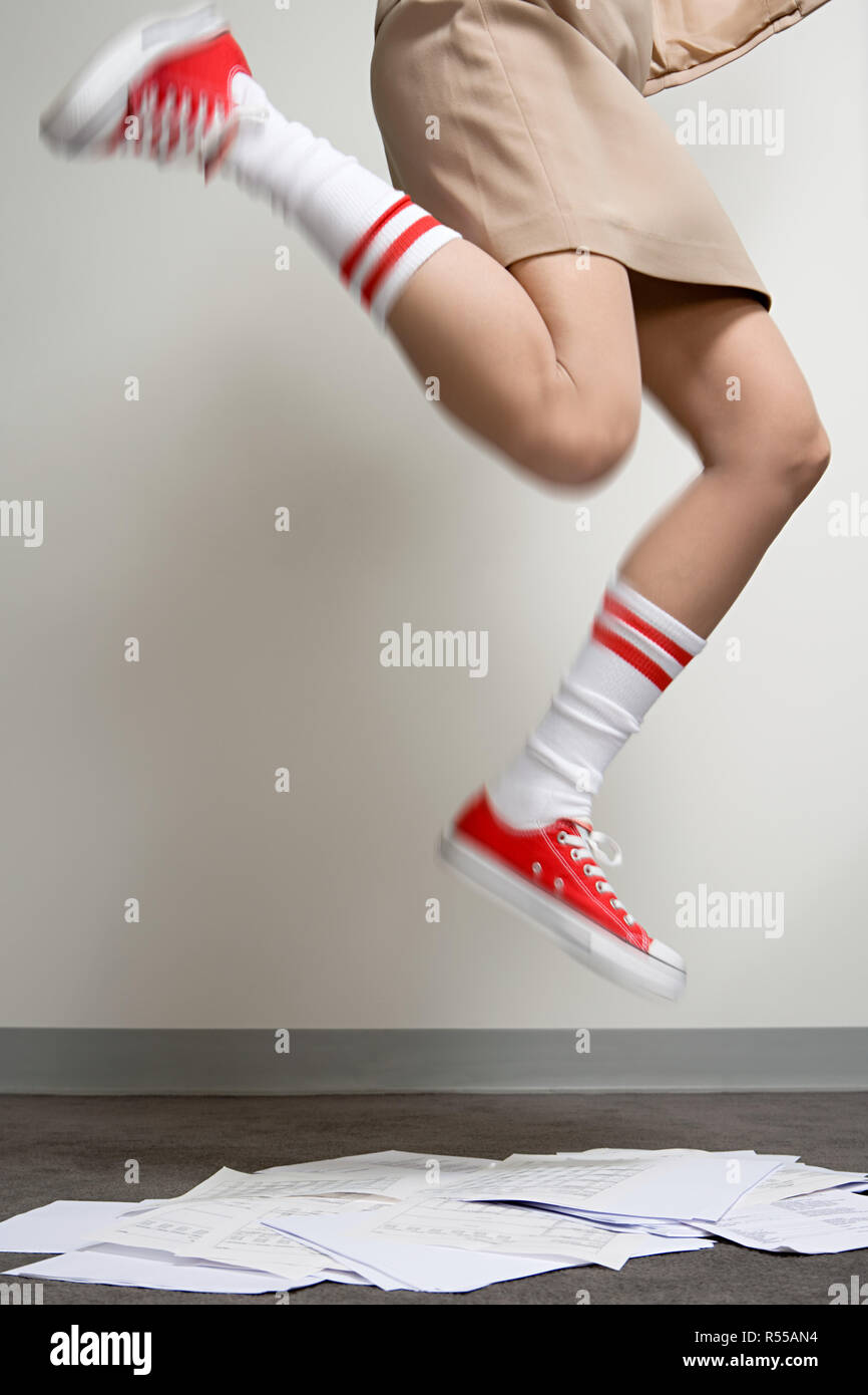 Female office worker wearing baseball boots Stock Photo