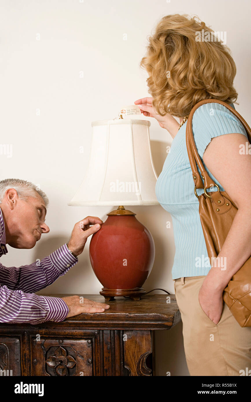 Couple looking at lamp Stock Photo