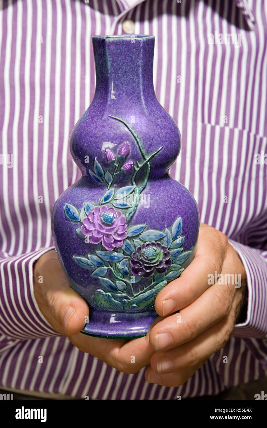 Man holding a vase Stock Photo