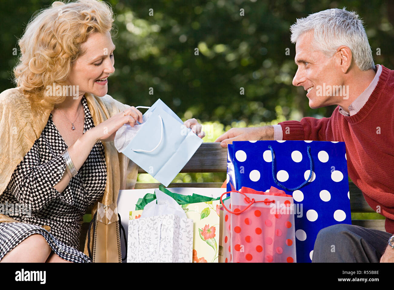 Woman looking in bag at gift from husband Stock Photo