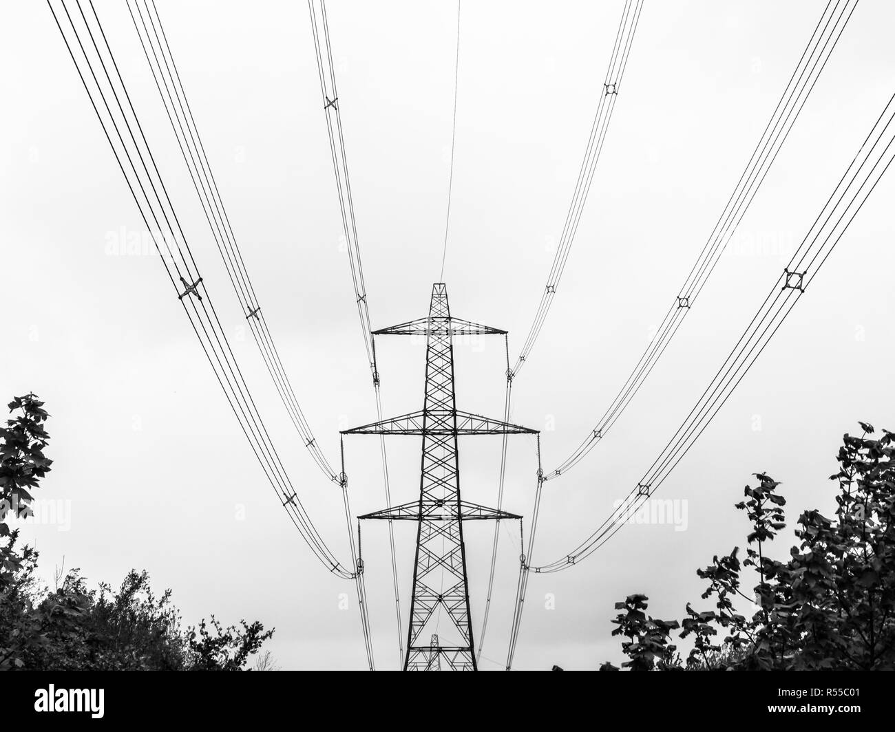The silhouette of an electricity pylon and cabling near Bolney in Mid-Sussex Stock Photo