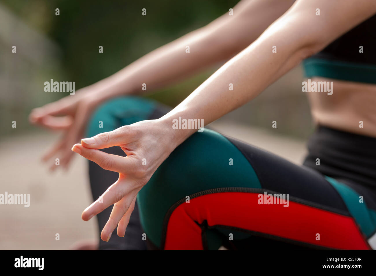 close up of a womans hands while meditating practicing yoga Stock Photo