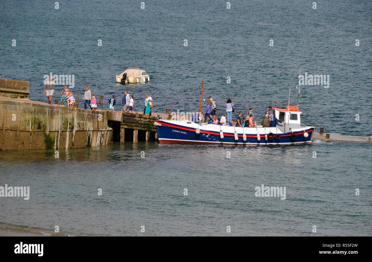 Ferry dropping tourists off at Caldey Island, near Tenby, Wales, UK Stock Photo
