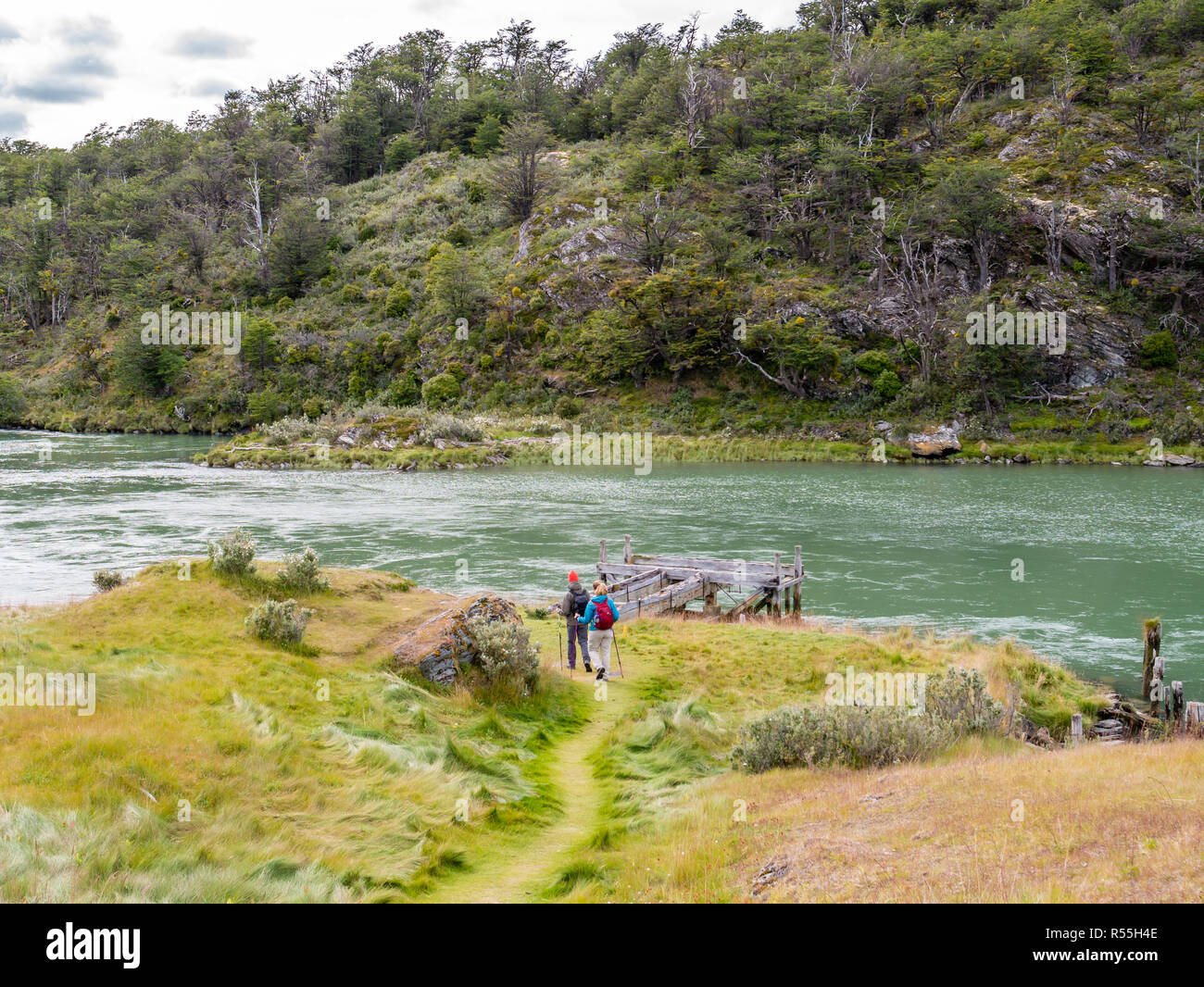 People walking on trail of Paseo de la isla, Island hike, along Lapataia River in Tierra del Fuego National Park, Patagonia, Argentina Stock Photo