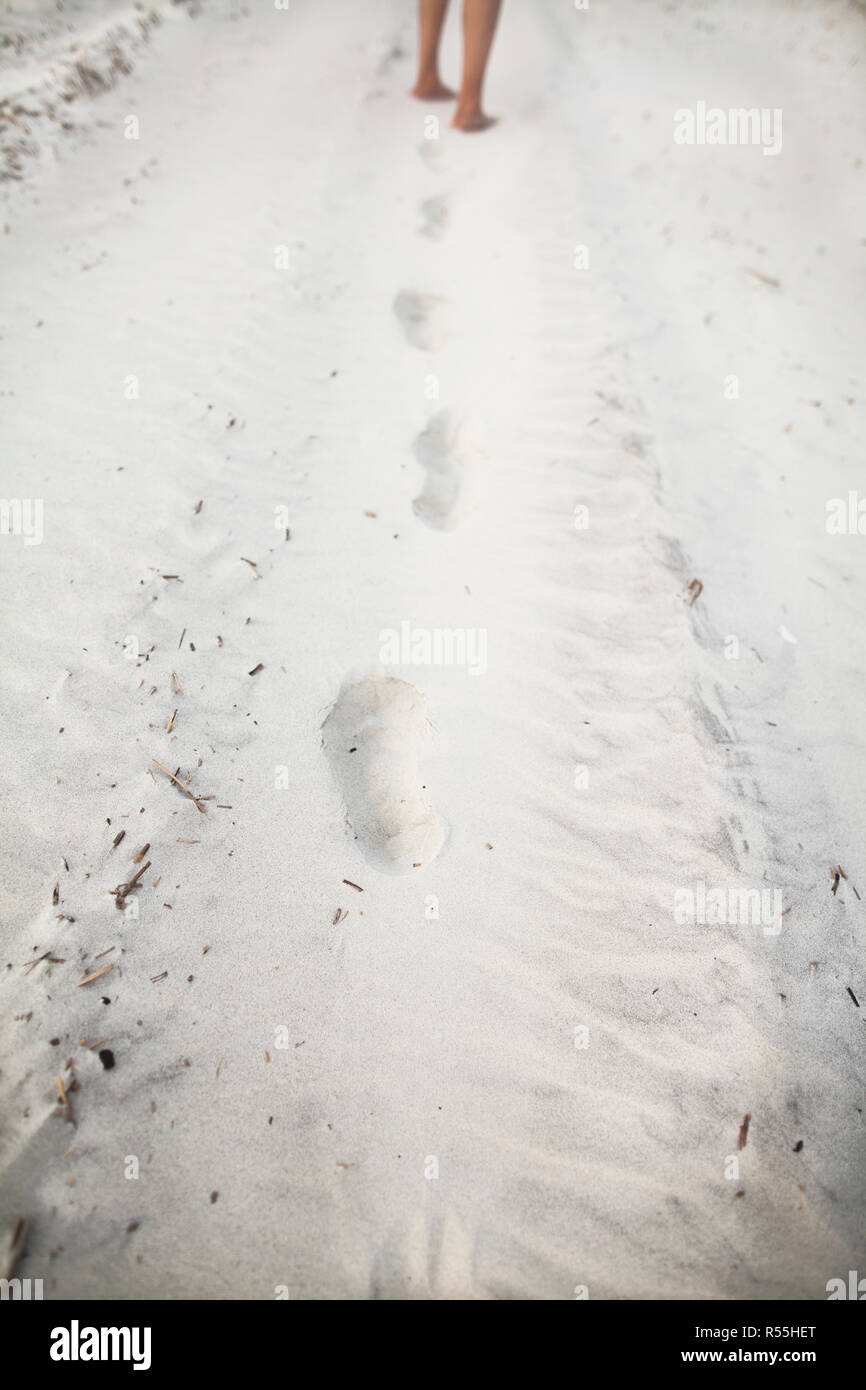 Person leaving footprints in sand at the beach Stock Photo - Alamy