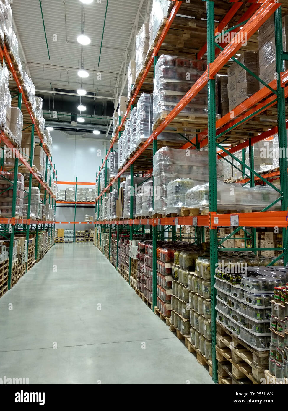 Rows of shelves with goods in a large store. Perspective Stock Photo