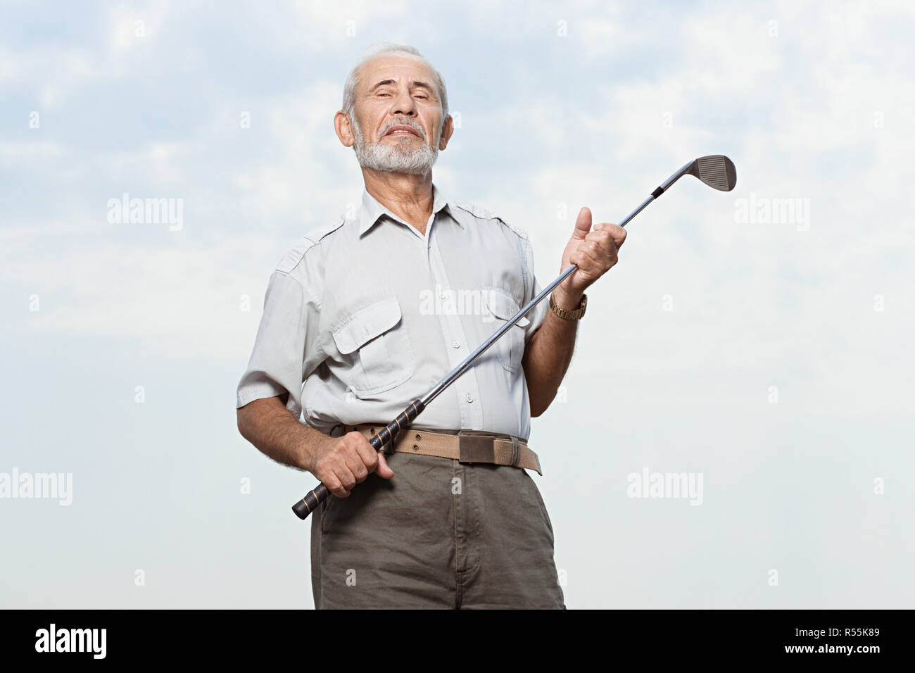 Man holding a golf club Stock Photo