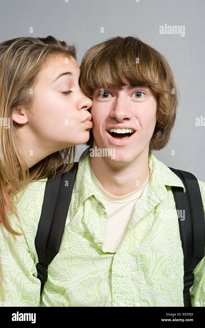 Girl giving boy a kiss on the cheek Stock Photo - Alamy