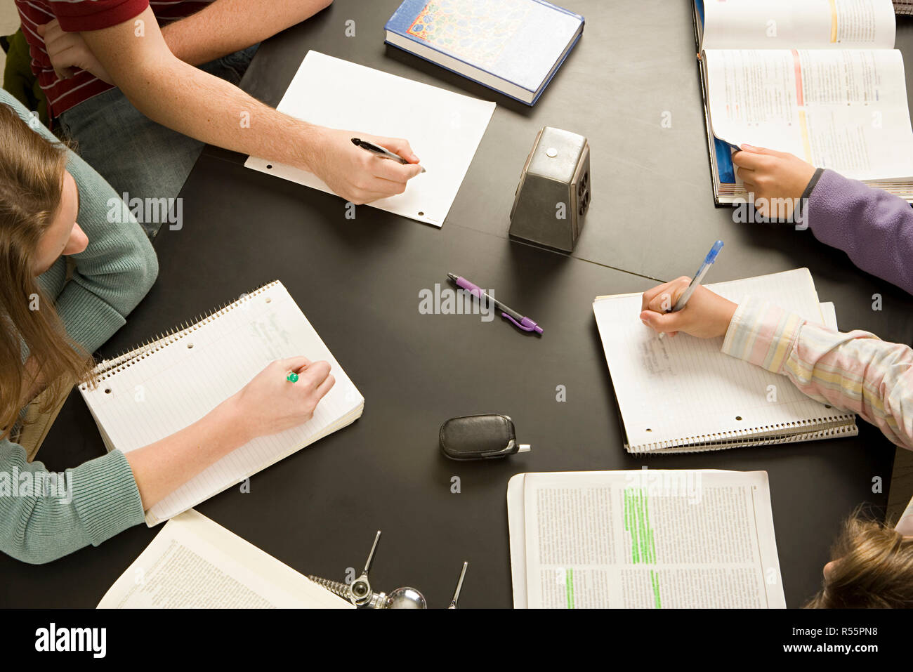 Four students working in a classroom Stock Photo
