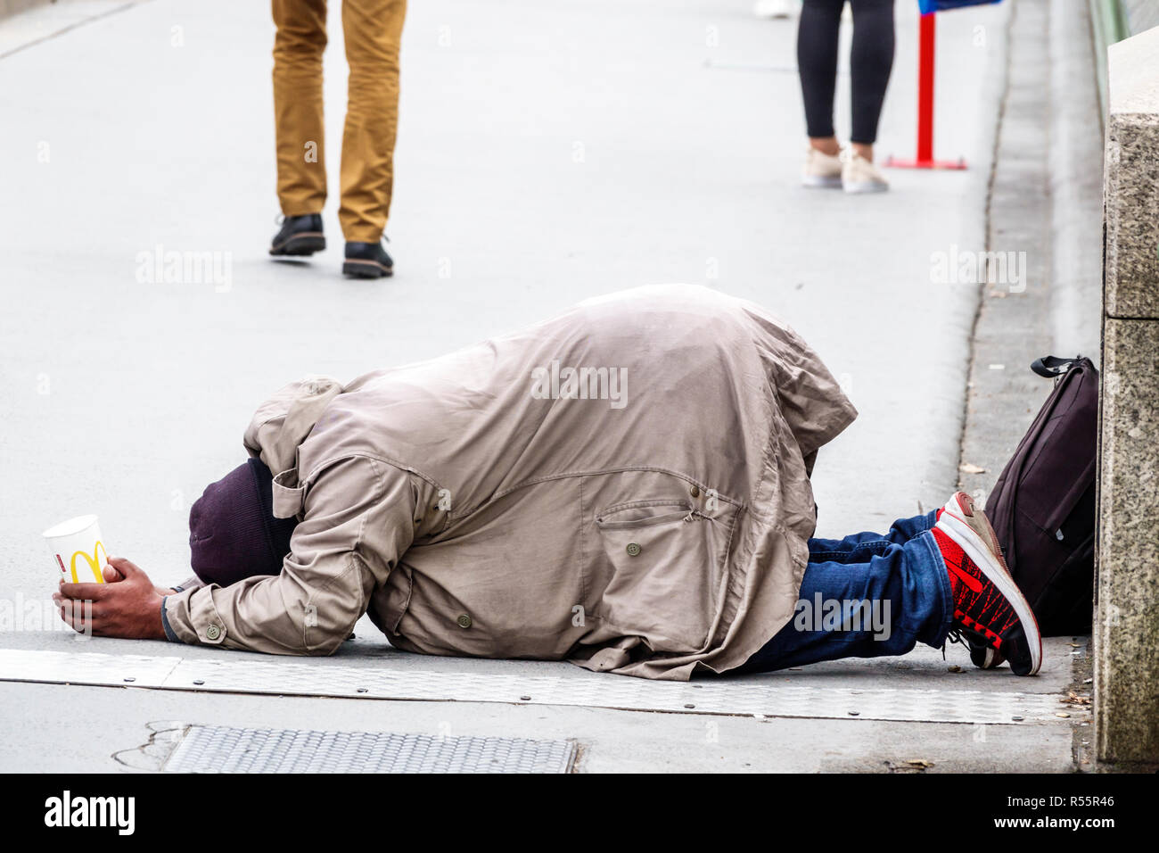 London England,UK,Westminster Bridge,Thames River,Asian man men male,prostrated on ground,holding McDonald's cup,begging,street beggar,UK GB English E Stock Photo
