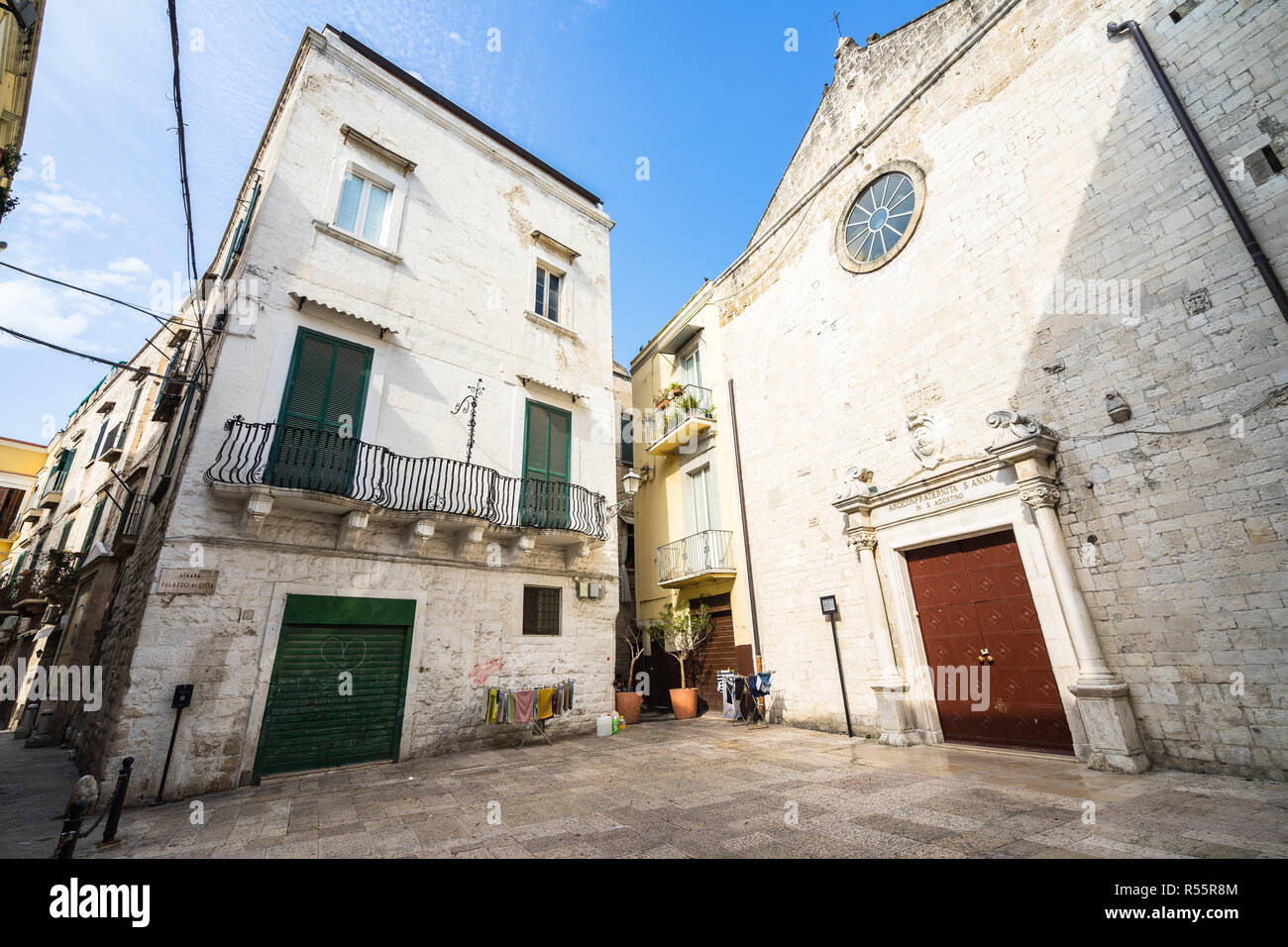 Small square with a traditional building and a small church in Bari old town (called in Italian 'Bari Vecchia'), Apulia, Italy Stock Photo