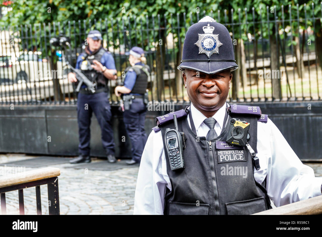 London England,UK,Palace of Westminster,Parliament,security,police officer,constable,body camera,bullet proof vest,uniform,custodian bobby helmet,Moto Stock Photo