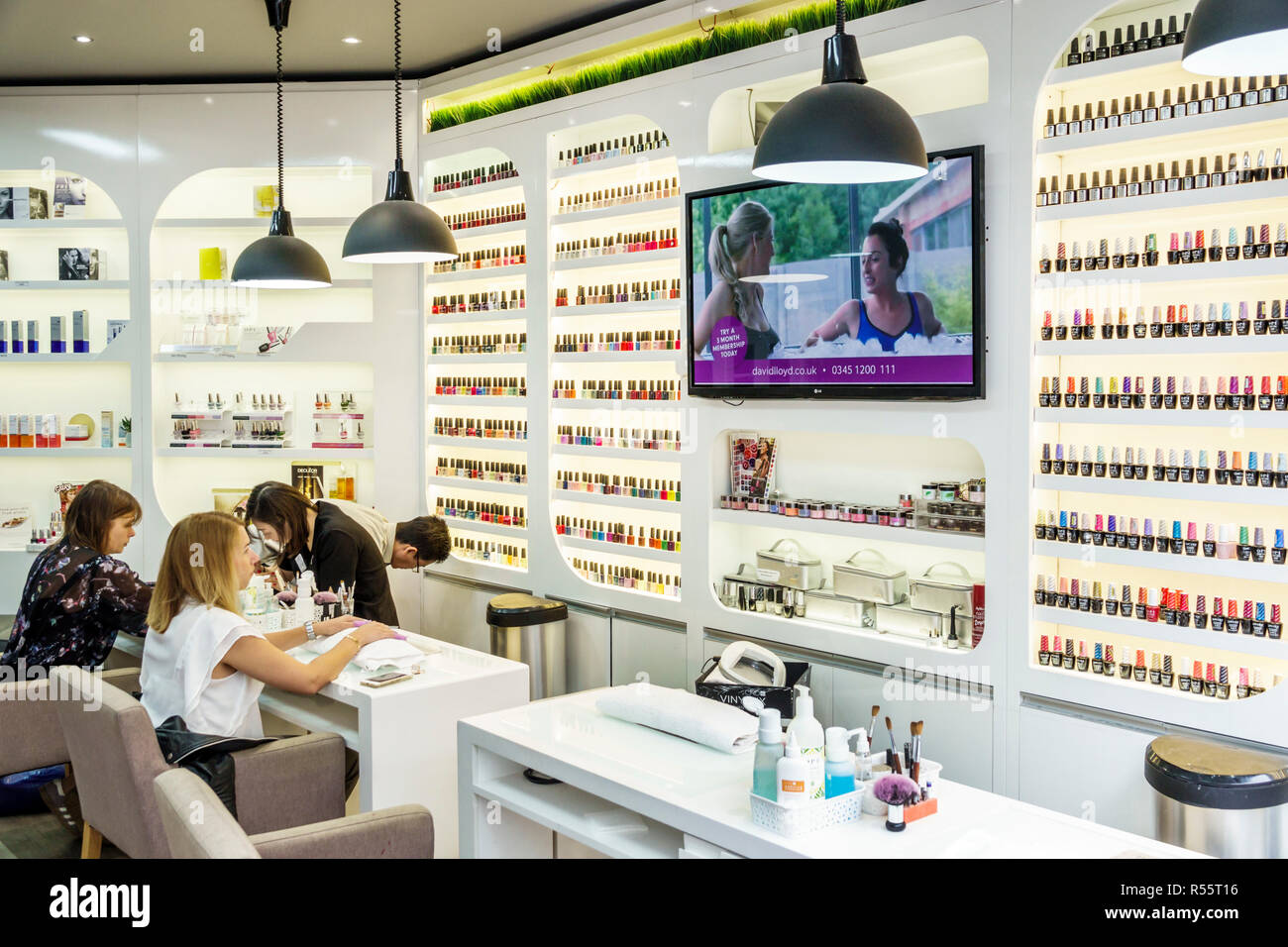 London England,UK,Westminster,nail beauty salon,manicures,nail polish bottles,display,man men male,woman female women,customer,technician,personal gro Stock Photo