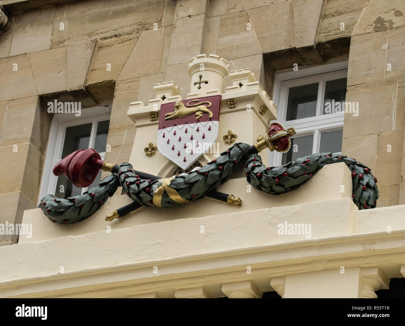 The heraldic coat of arms of Chichester City Council as seen above the
