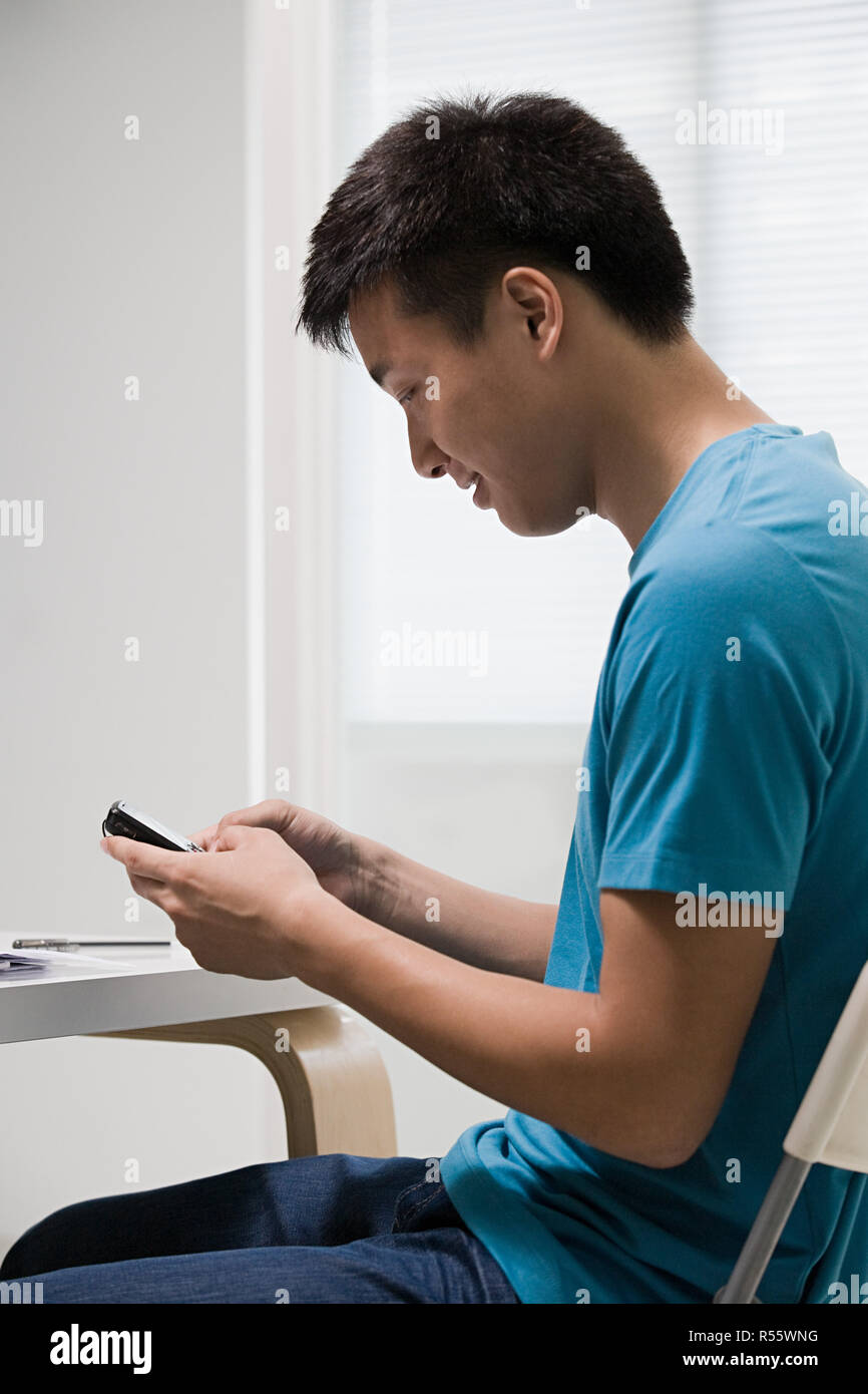 Young man using cellphone Stock Photo