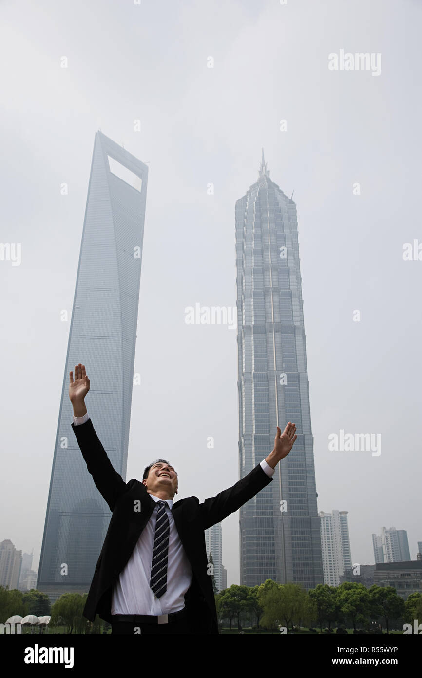 Joyous businessman with his arms raised Stock Photo - Alamy