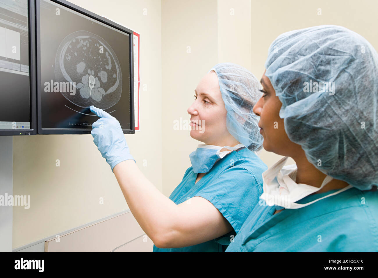 Surgeons looking at scan Stock Photo