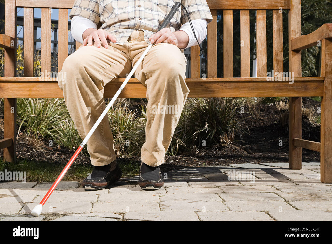 Blind man sitting on a bench Stock Photo