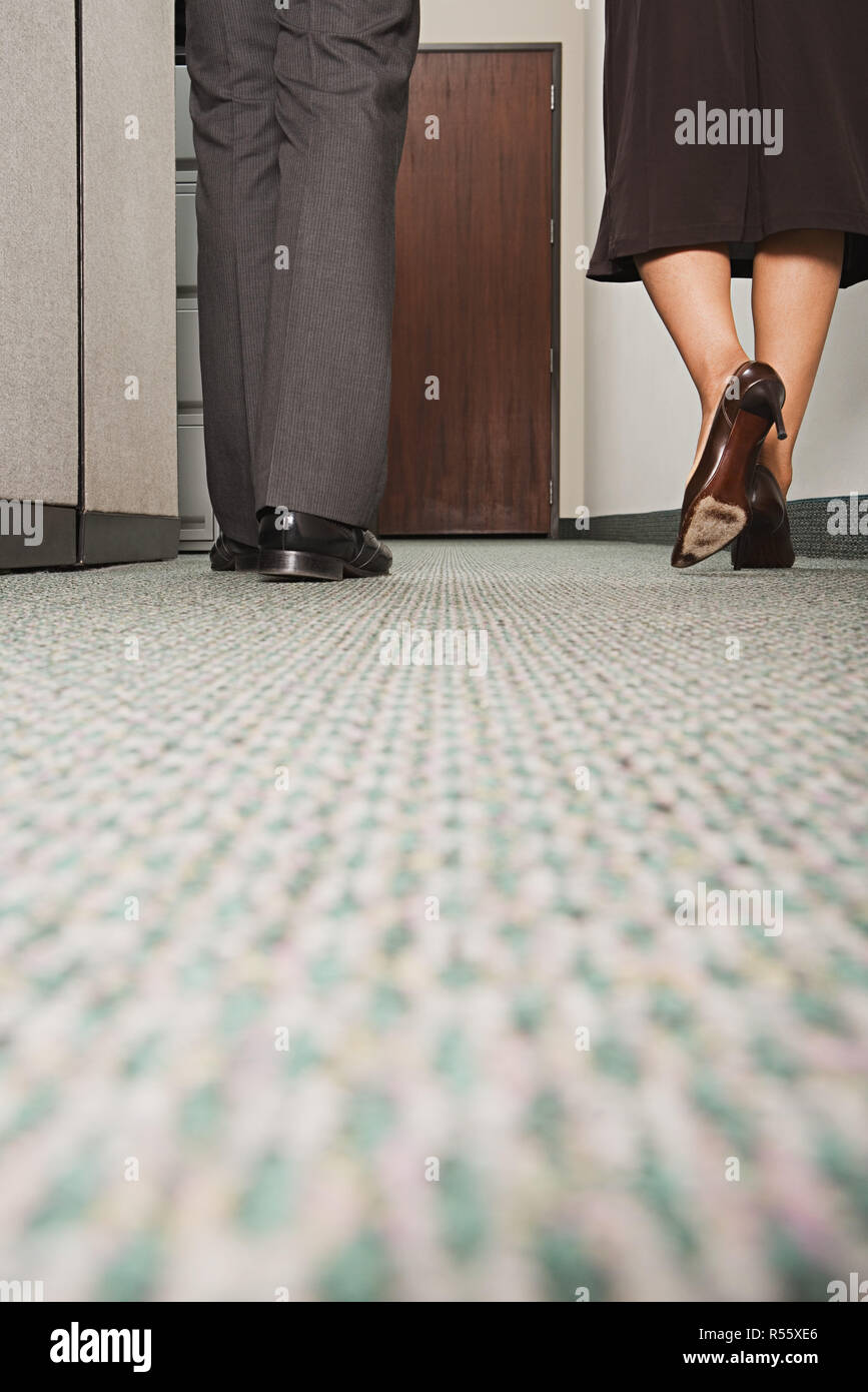 Two colleagues walking along corridor Stock Photo