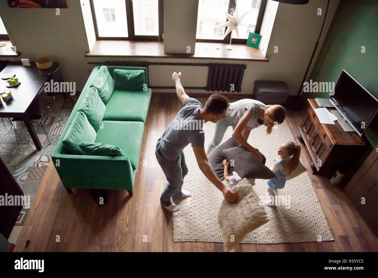 Young family playing pillows fight with son and daughter Stock Photo