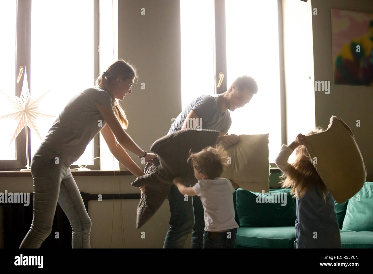 Young family playing pillows fight with son and daughter Stock Photo