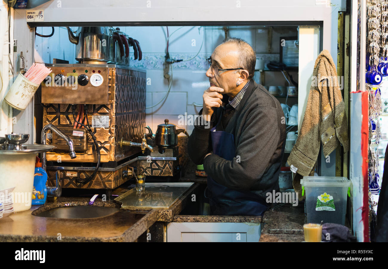 ISTANBUL, TURKEY - APRIL 2015: tea maker looking out of his kiosk at Grand Bazaar. Stock Photo