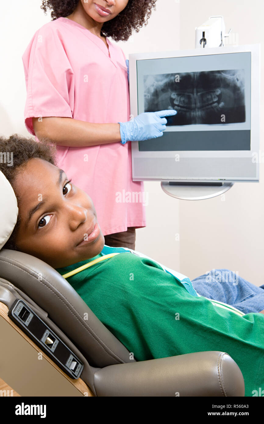 Dental nurse showing patient x ray Stock Photo