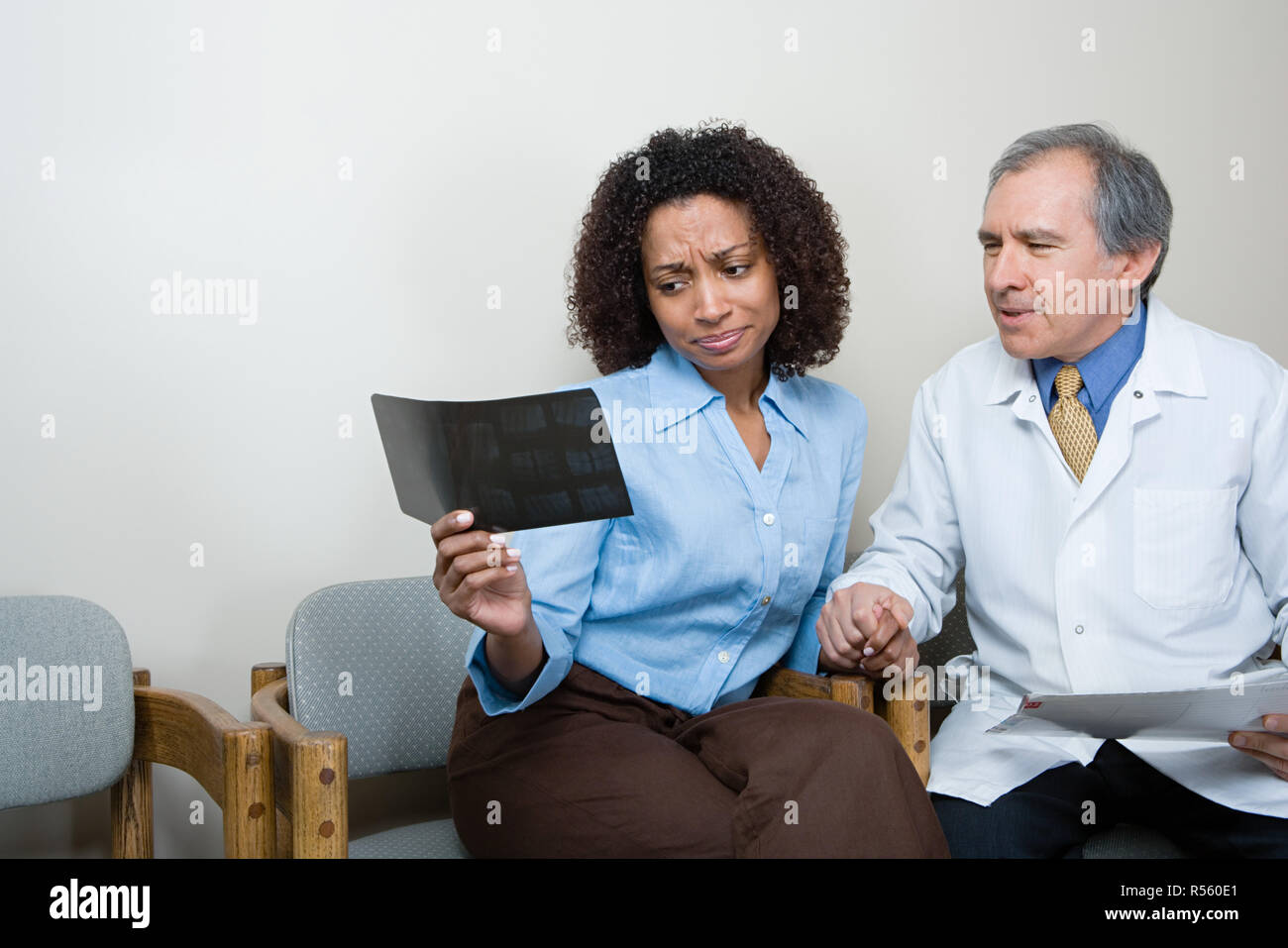 Dentist showing patient x ray Stock Photo