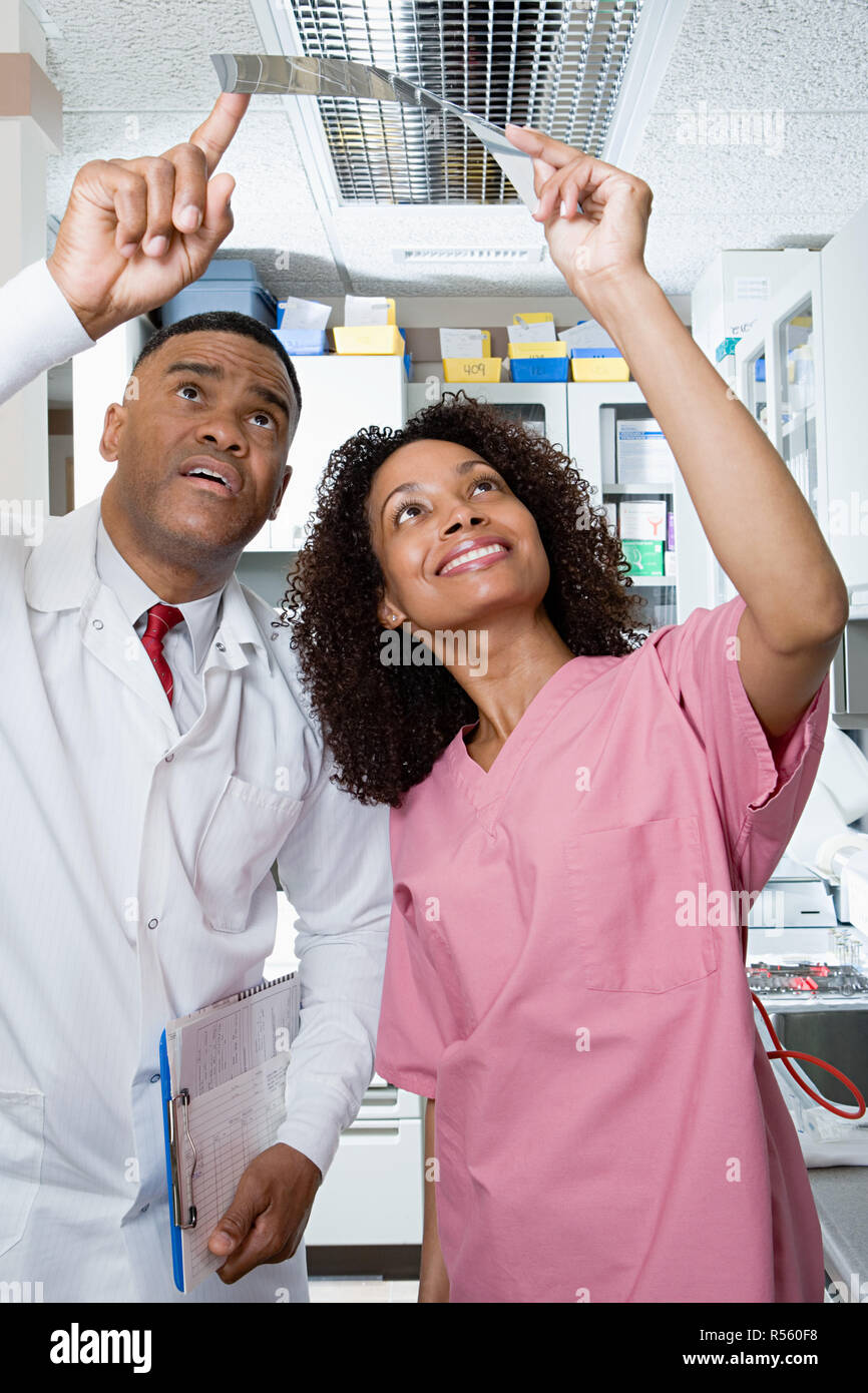 Dentist and dental nurse looking at x ray Stock Photo Alamy