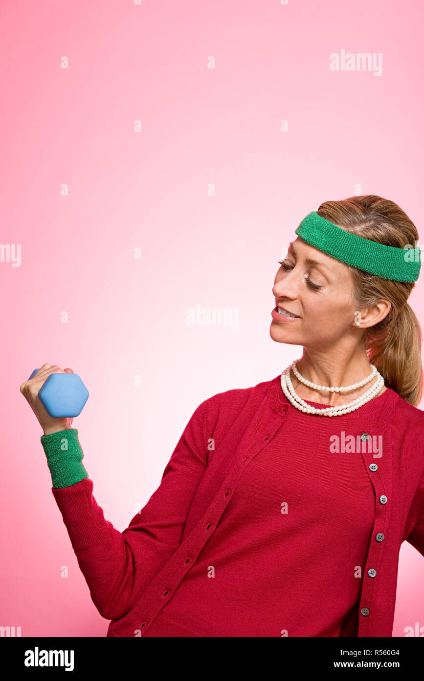 Woman lifting a dumbbell Stock Photo