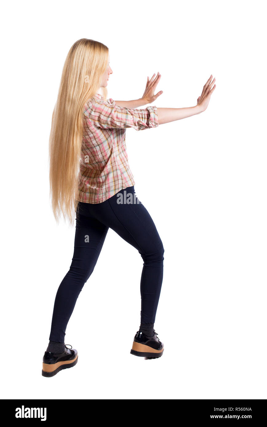 Pushing Back View back view of woman pushes wall. Isolated over white background. Rear ...