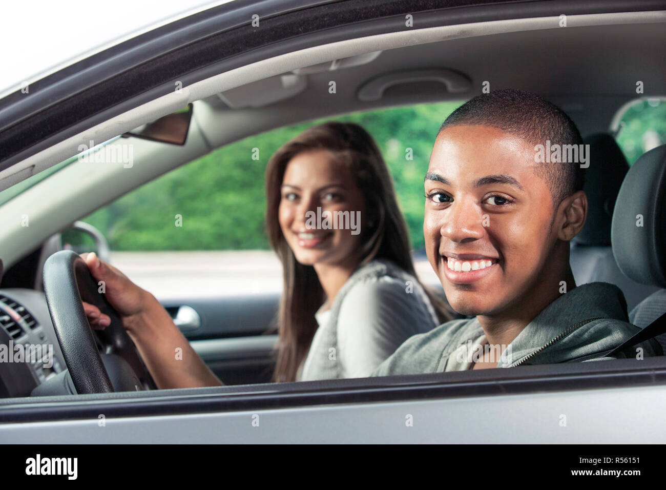 Teenagers driving car Stock Photo - Alamy