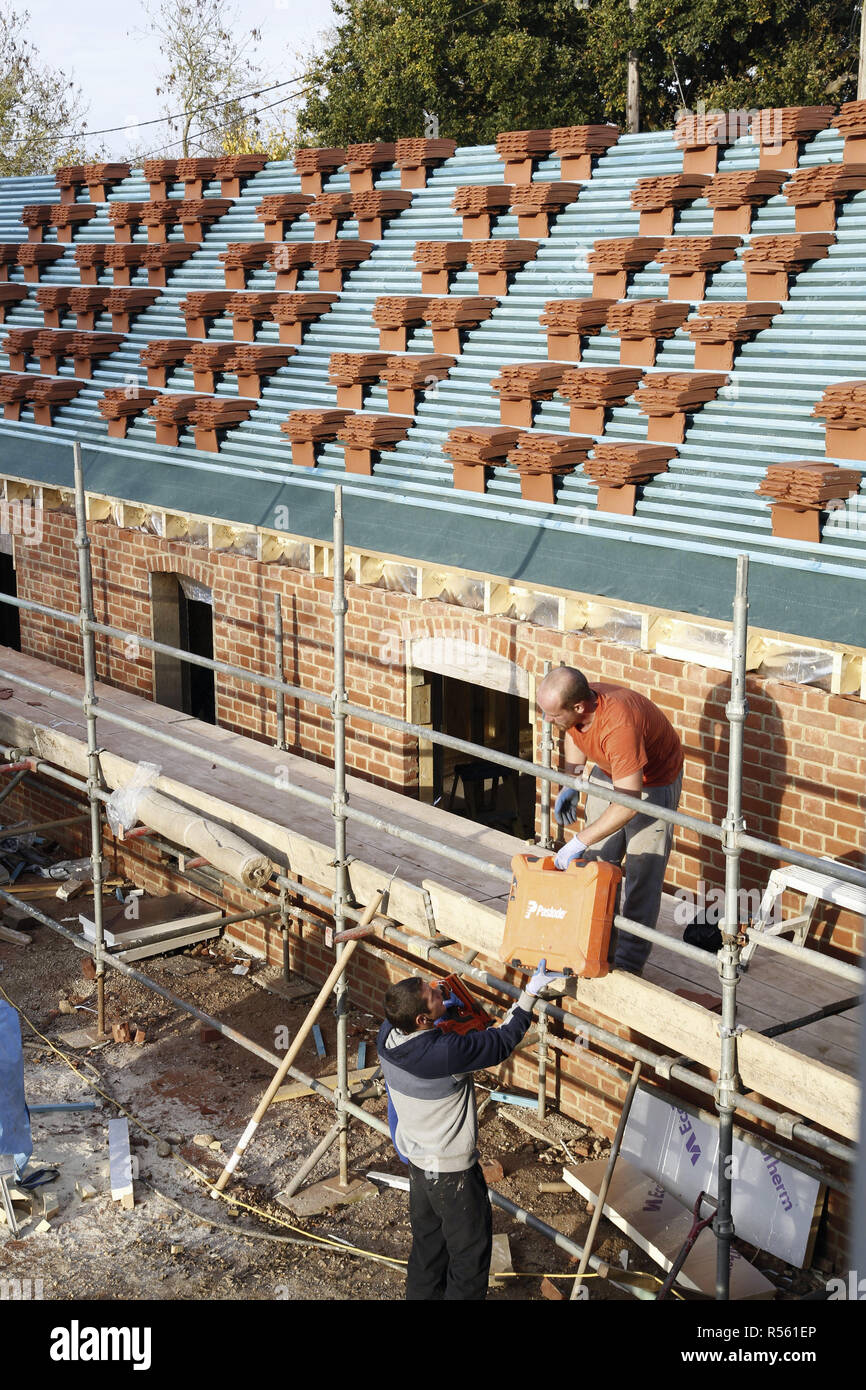 Buckingham, UK November 03, 2016. Roofers work on a new build. Clay