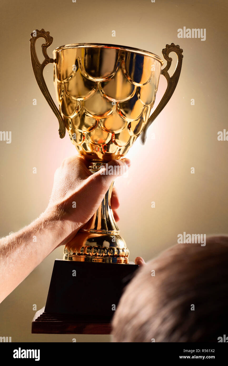 Athlete holding trophy cup Stock Photo Alamy