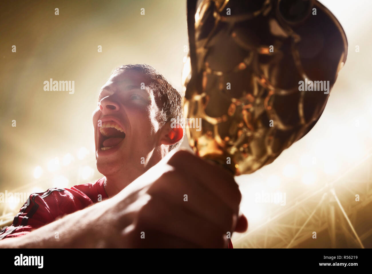 Athlete cheering with trophy cup Stock Photo Alamy