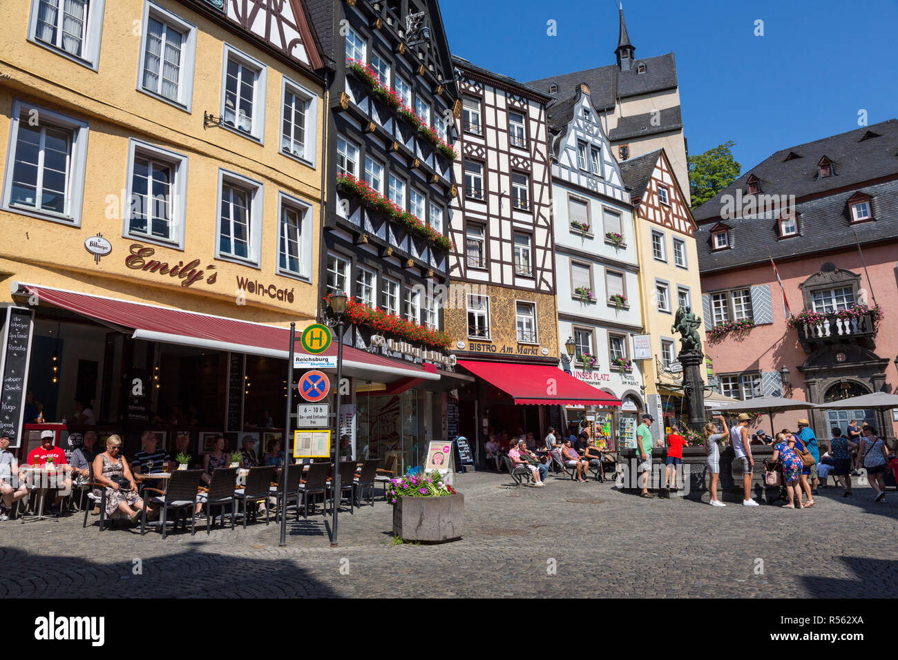 Cochem, Germany.  Market Square, Tourists around St. Christopher Fountain. Stock Photo