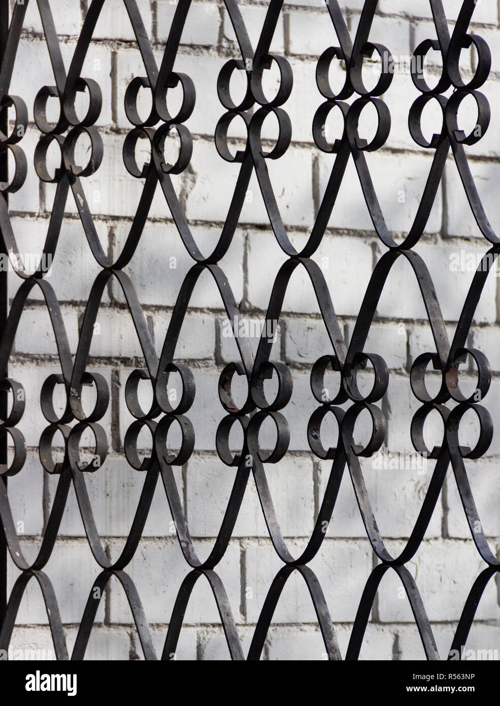 Forged Steel Metal Decorative Grille On A White Brick Wall