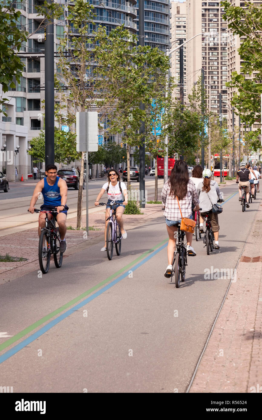 Cyclists using a bike lane on the Martin Goodman Trail that follows Toronto's waterfront on Queens Quay. City of Toronto, Ontario, Canada. Stock Photo